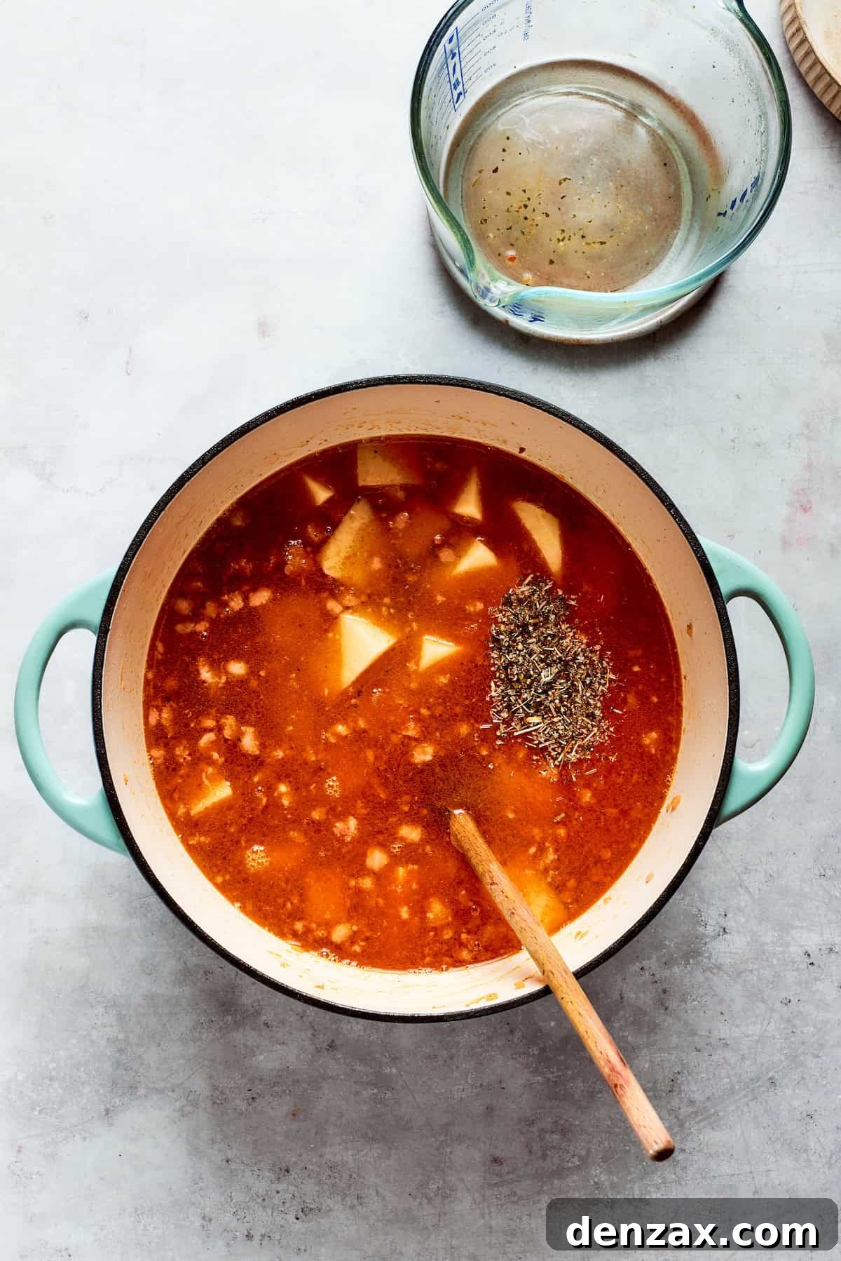 Broth is added in to the pot.