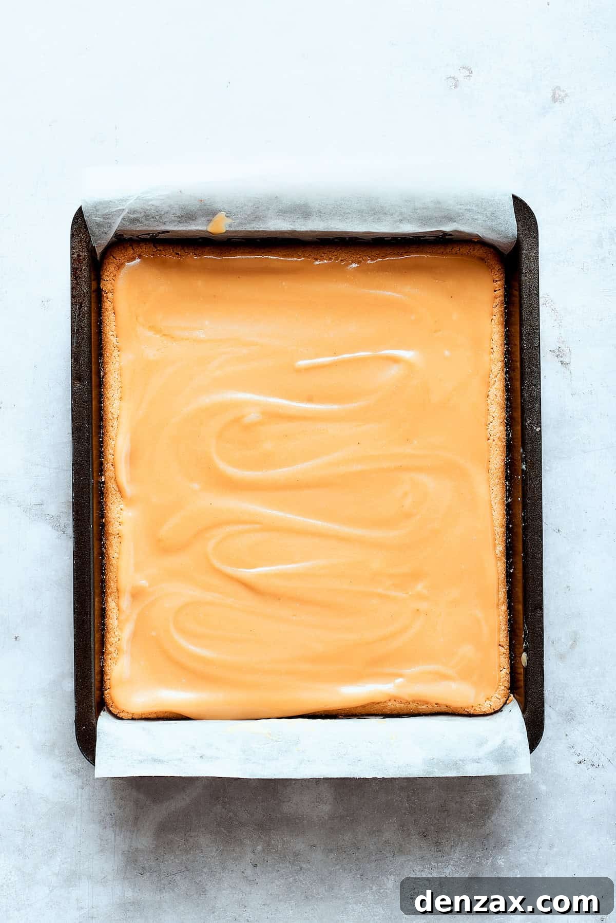 Caramel sauce is added to the shortbread.