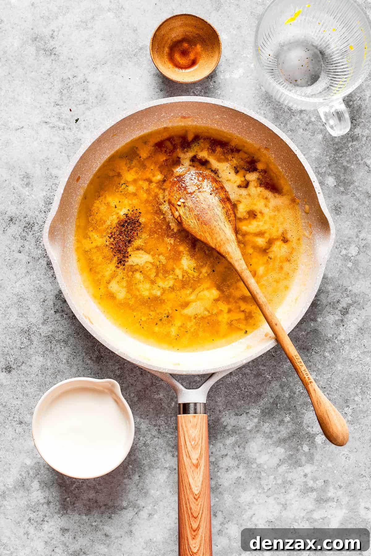 Flour is cooked into roux in a pan.