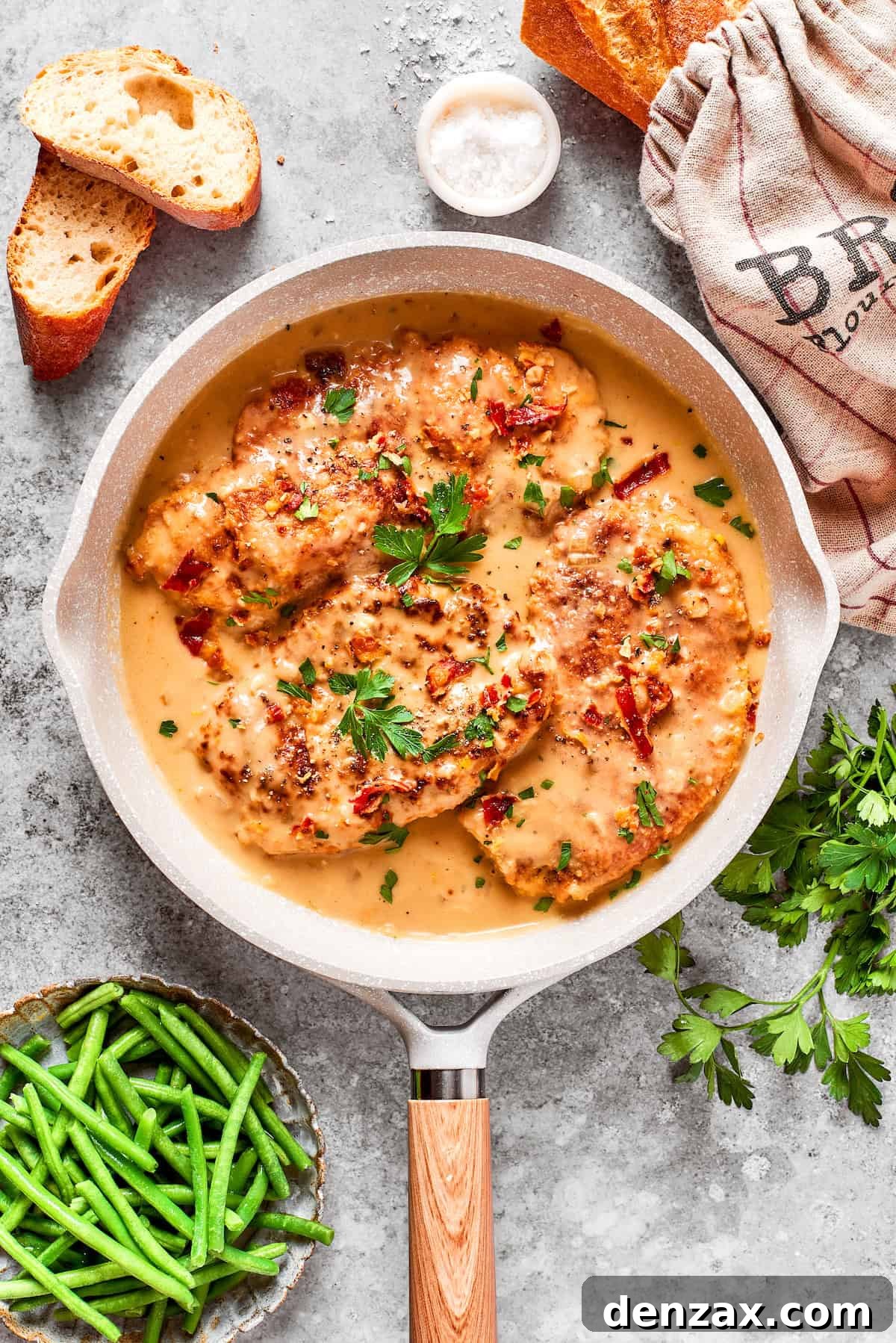 A pan of gravy and smothered chicken.