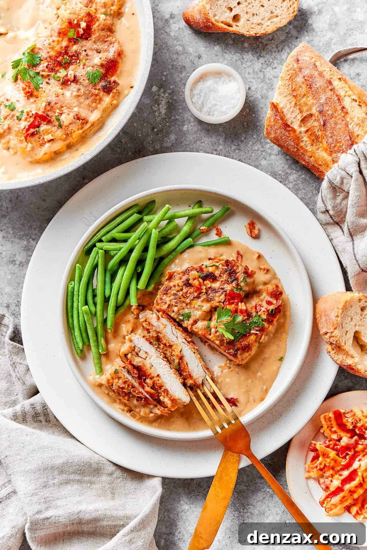 A plate of smothered chicken with green beans on a table.