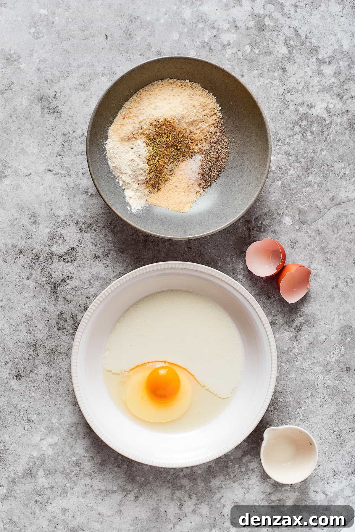 A bowl of breadcrumbs and seasoning and a bowl of egg.