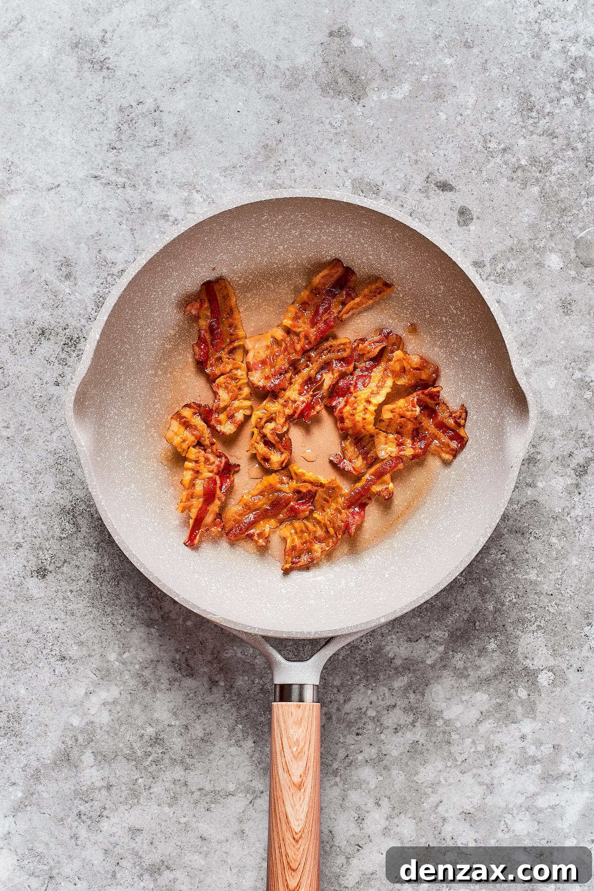 Bacon is cooked in a pan.