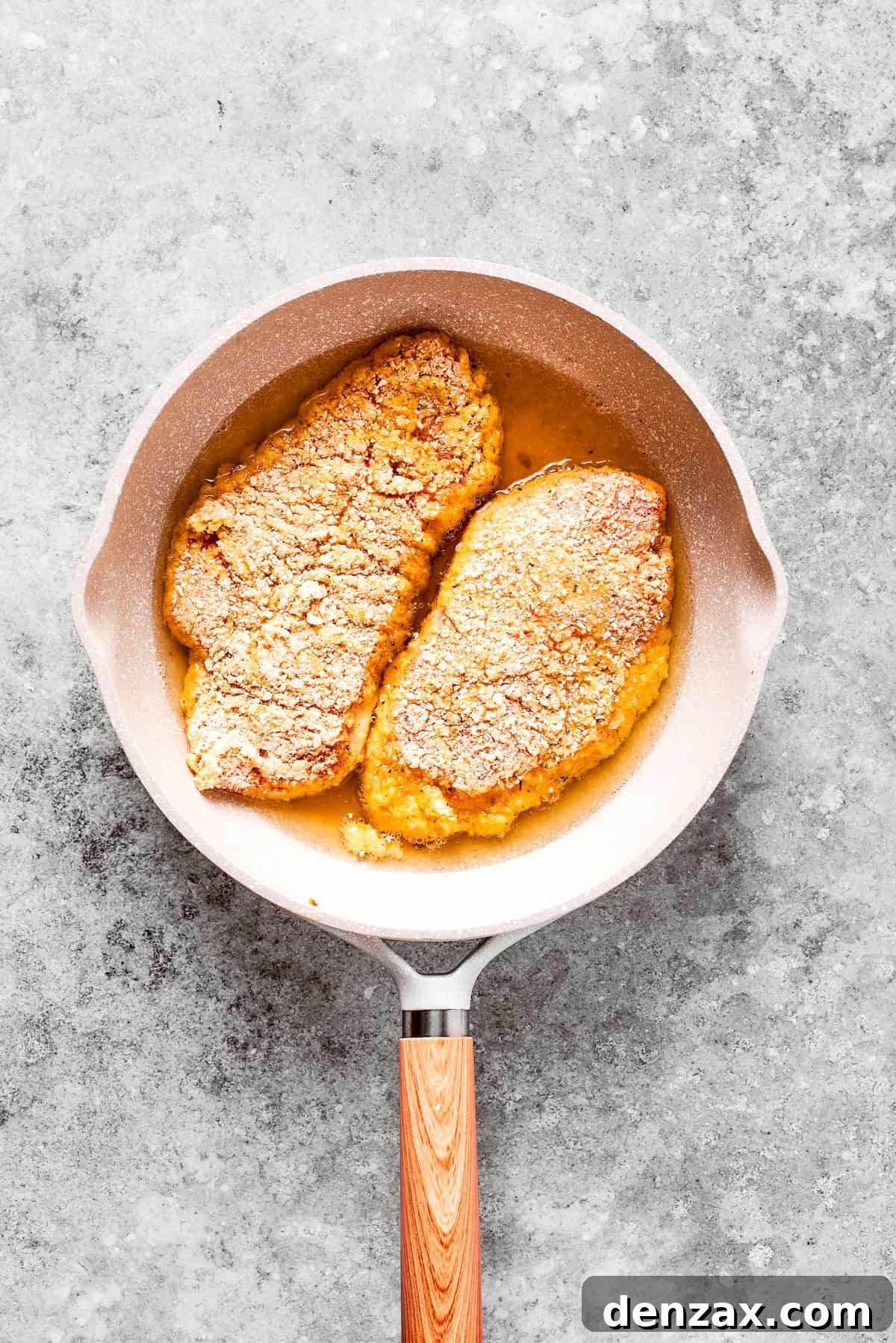 Two chicken breasts are pan friend.