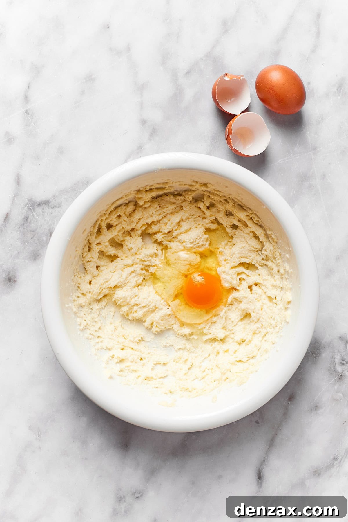 An egg is added to cookie dough.