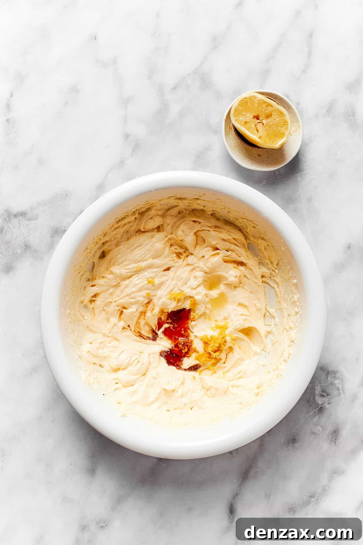 Vanilla is added to a bowl of dough.