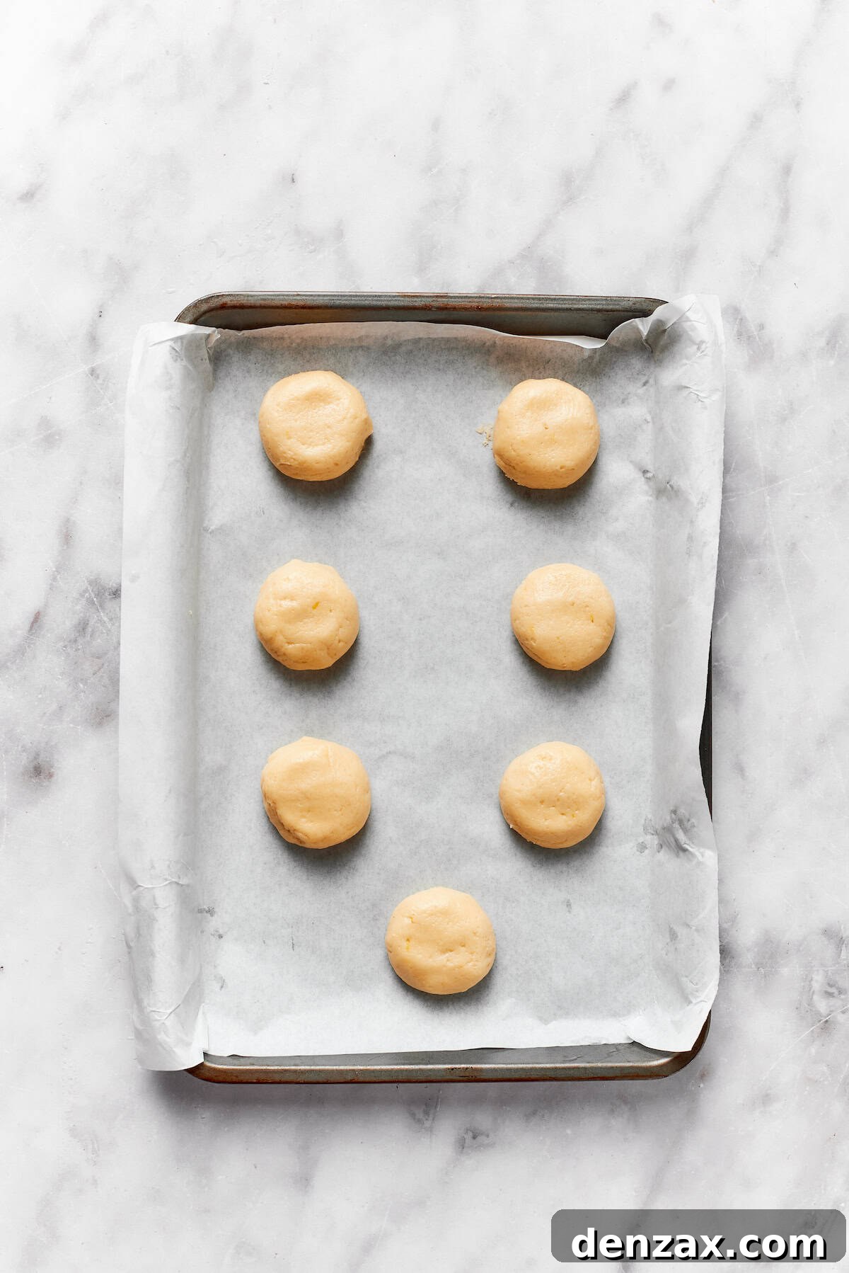 Anginetti cookie dough on a baking sheet.