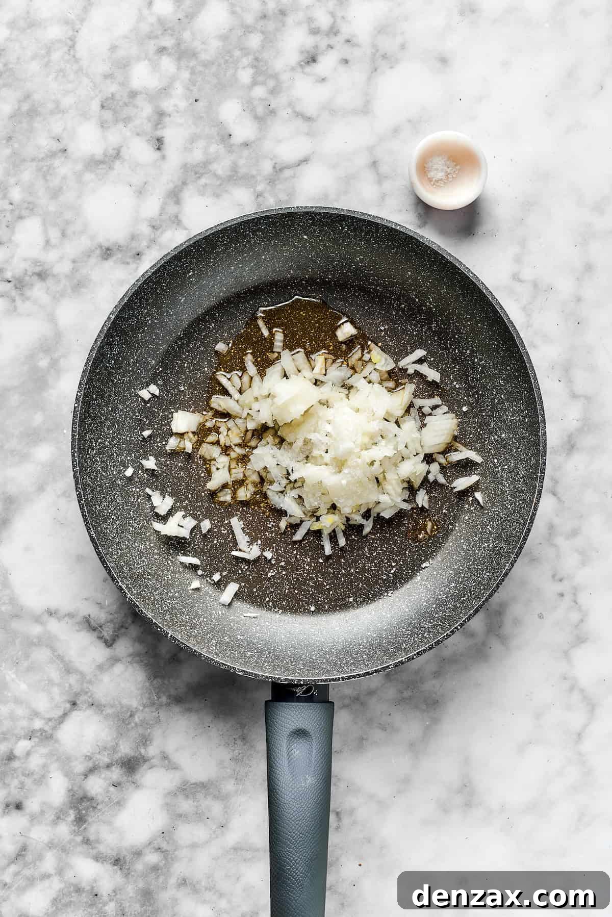 Onions in a skillet ready to cook.