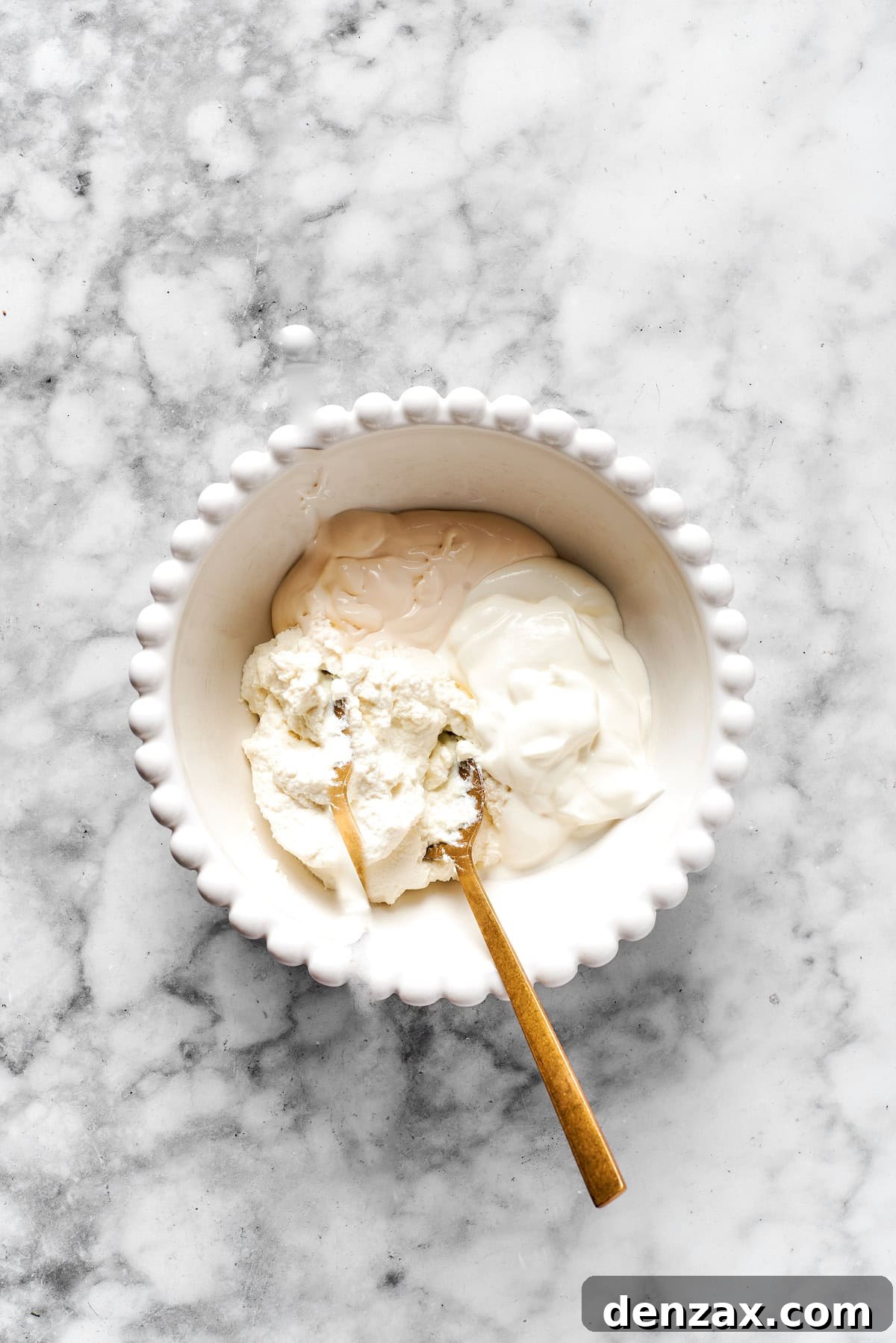 Added cheese mixture ingredients to a white bowl.