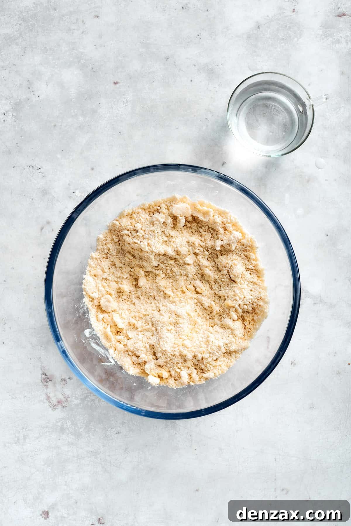 Combine Bisquick and water and mix. Mixing dough ingredients in a glass bowl.