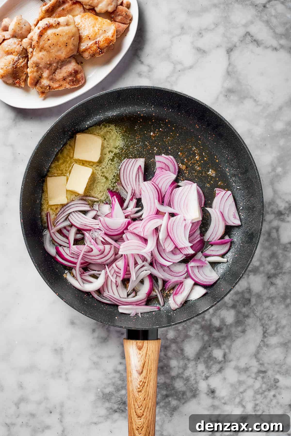 Red onions and butter in a pan.