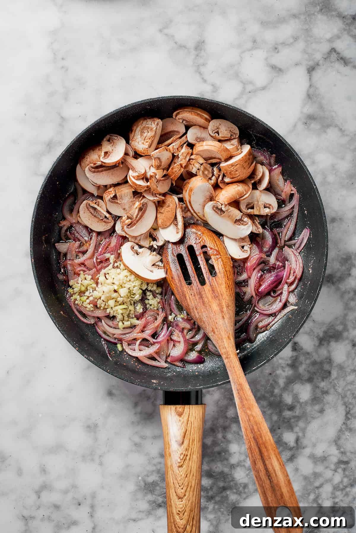 Mushrooms, onions and butter in a pan.