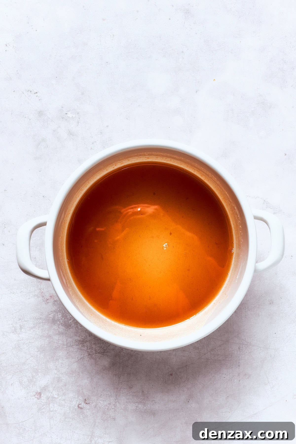 A pot of reduced apple cider.