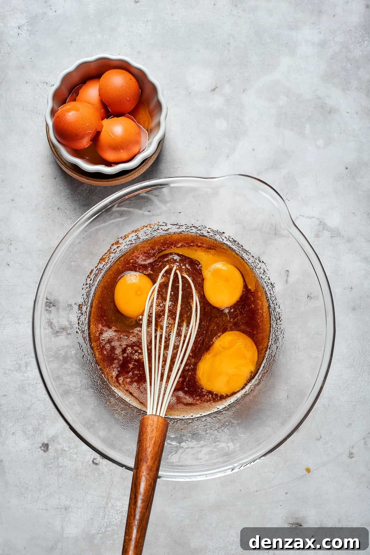 Eggs and egg yolk are added to browned butter and sugar.