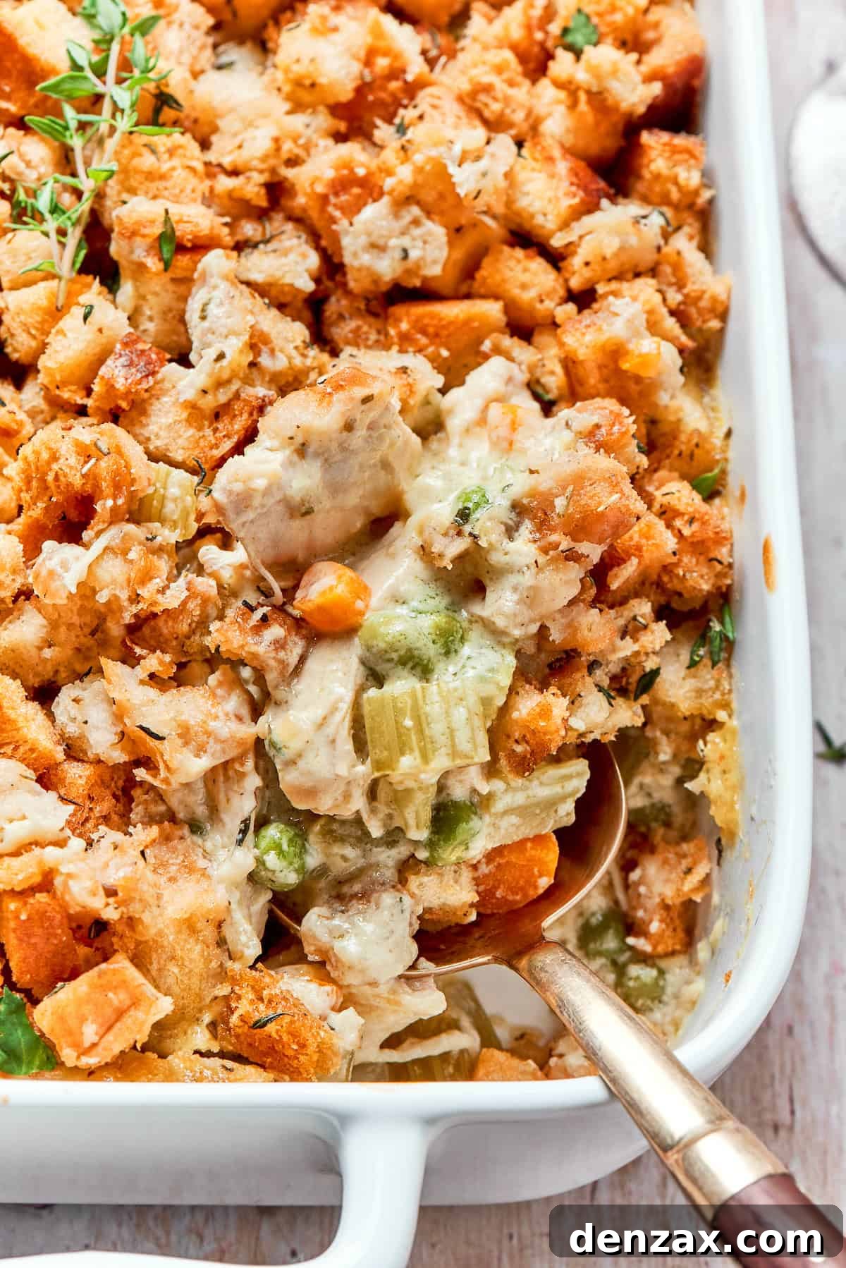 This chicken stuffing casserole features tender chicken filling with veggies topped with classic stuffing. An easy recipe baked until golden! Chicken stuffing casserole in a baking dish.
