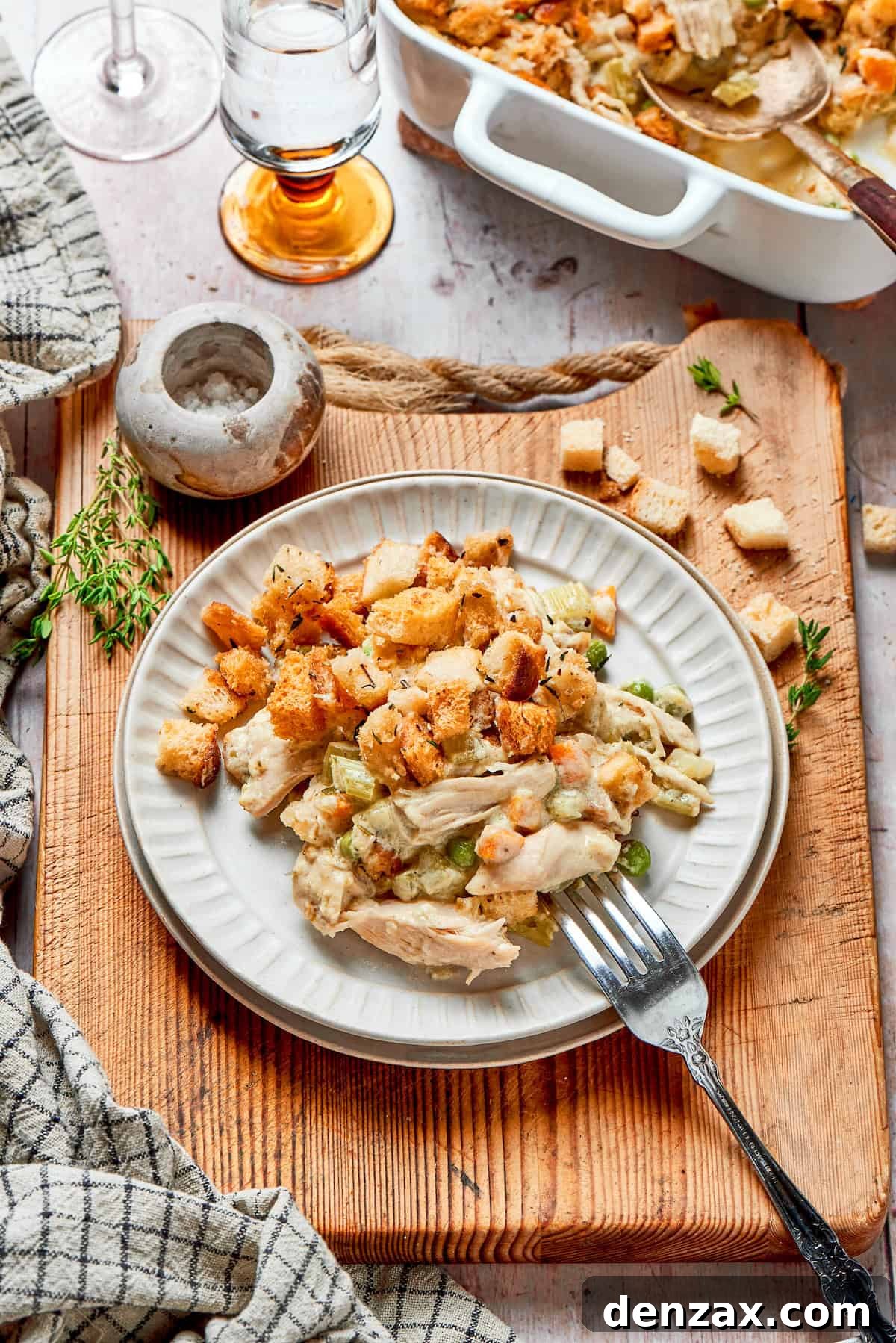 This chicken stuffing casserole features tender chicken filling with veggies topped with classic stuffing. An easy recipe baked until golden! Serving of chicken stuffing casserole on a plate.