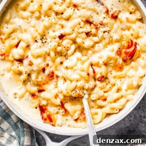 A skillet with mac and cheese and bacon stirred in.
