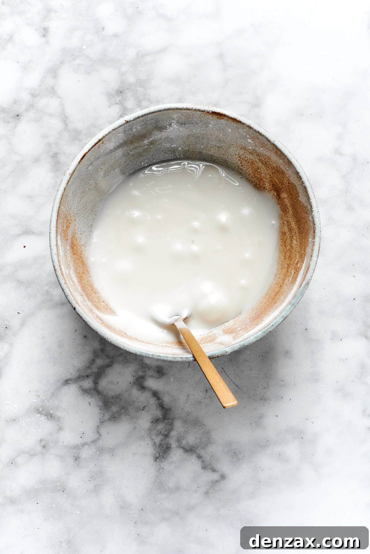 White icing mixed in a bowl.