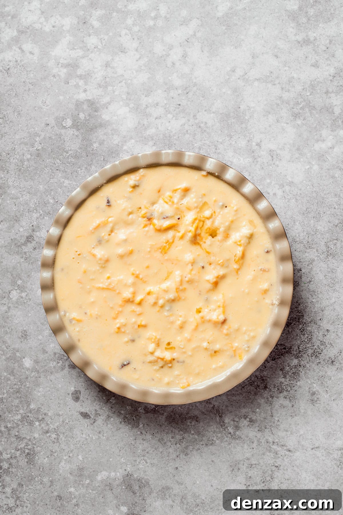 Biscuit dough added to a pan of cheeseburger pie.
