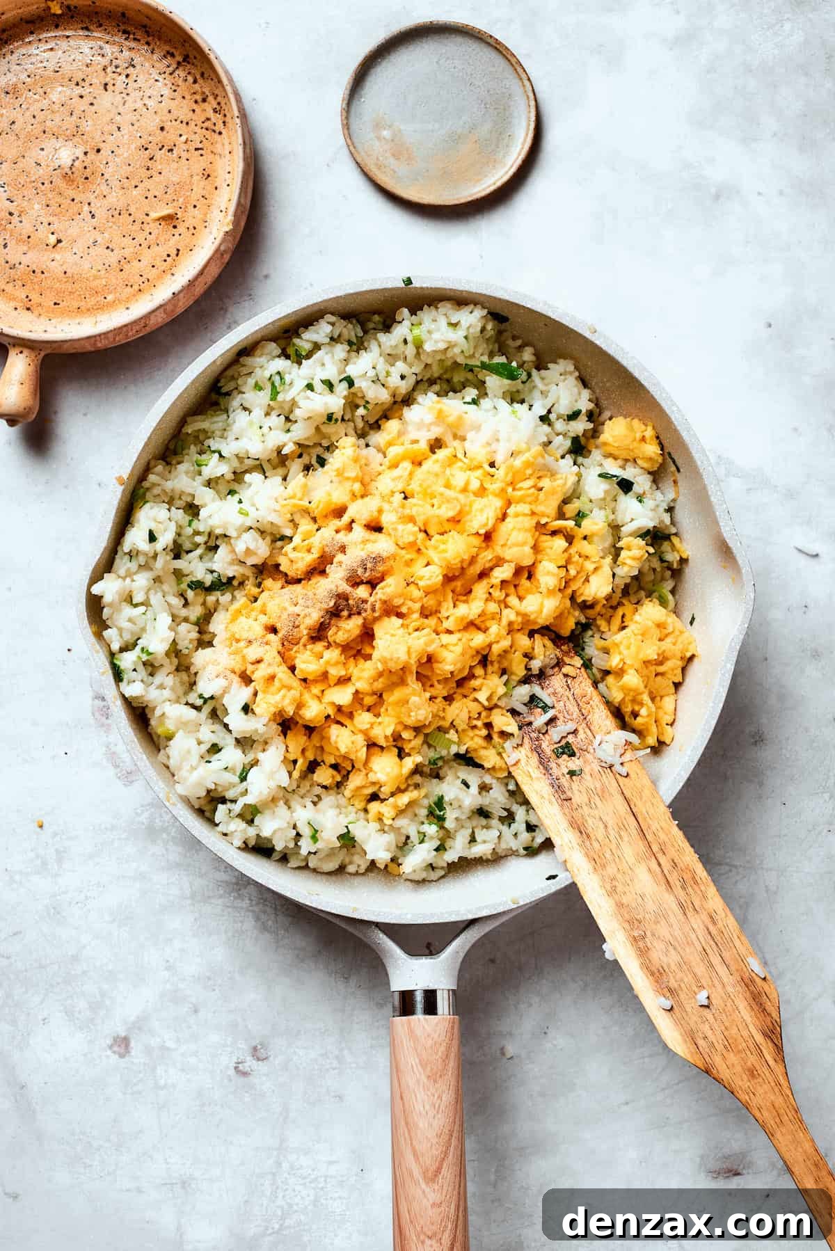 Scrambled eggs are added to rice.