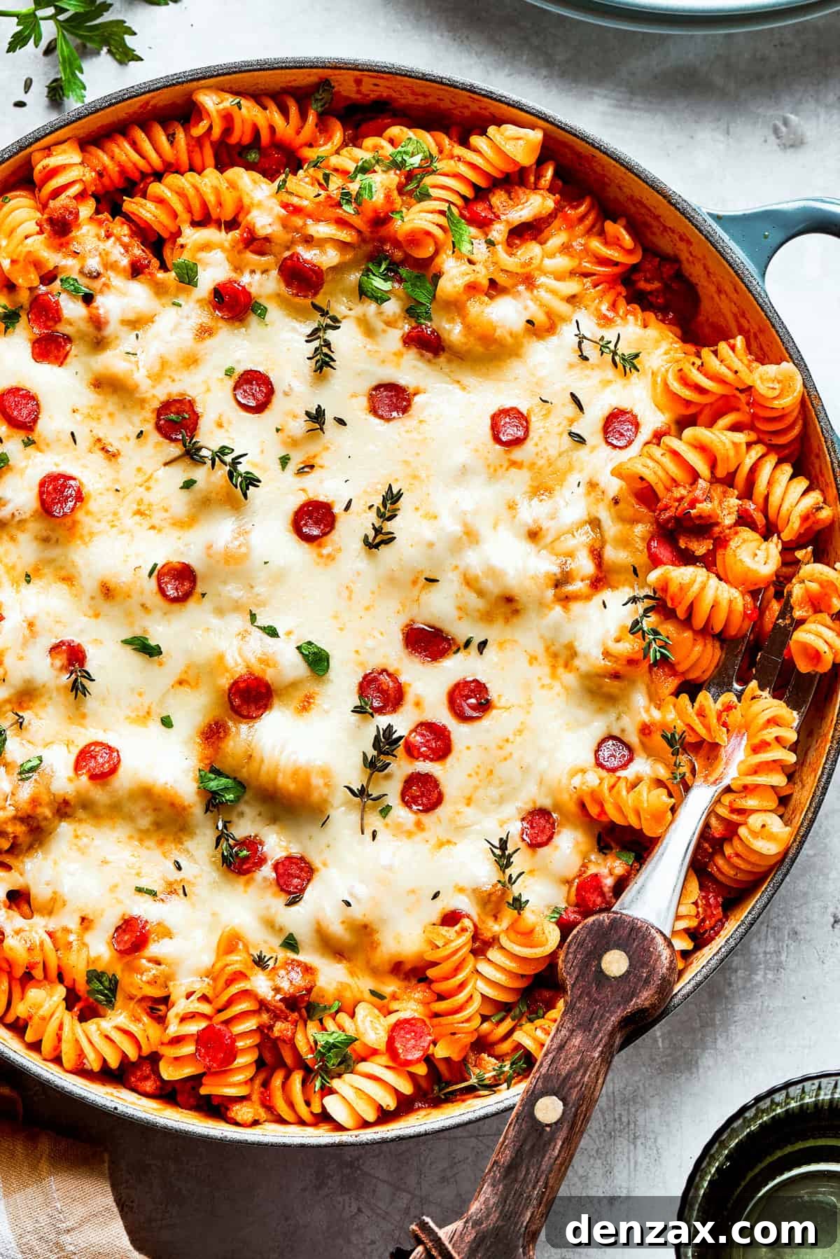 A big pan of pizza pasta topped with melted cheese and pepperoni.