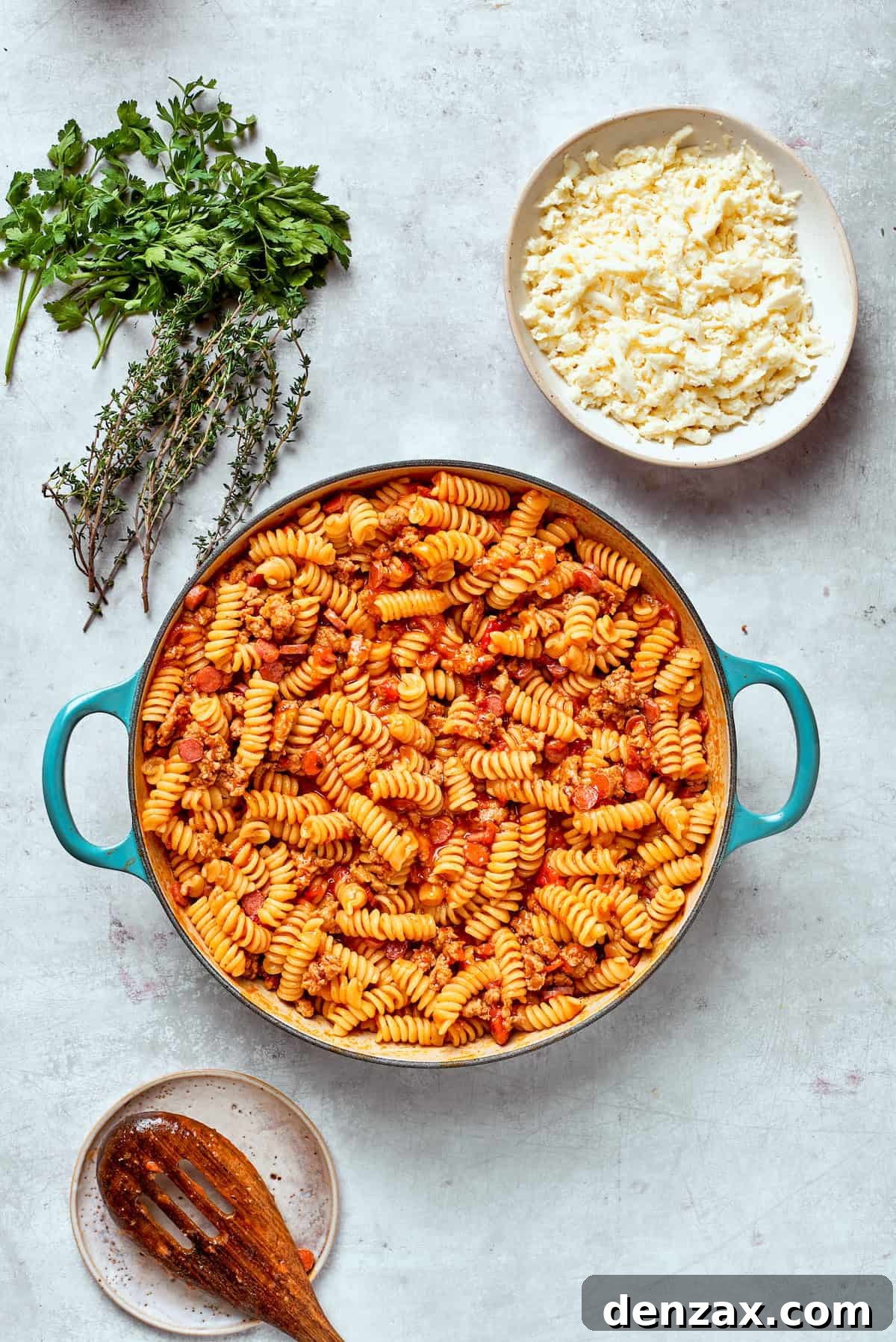 The pasta and sauce wait to be topped with cheese.