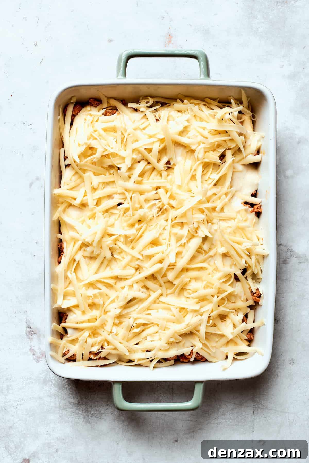 Cheese is added to biscuits and gravy casserole.