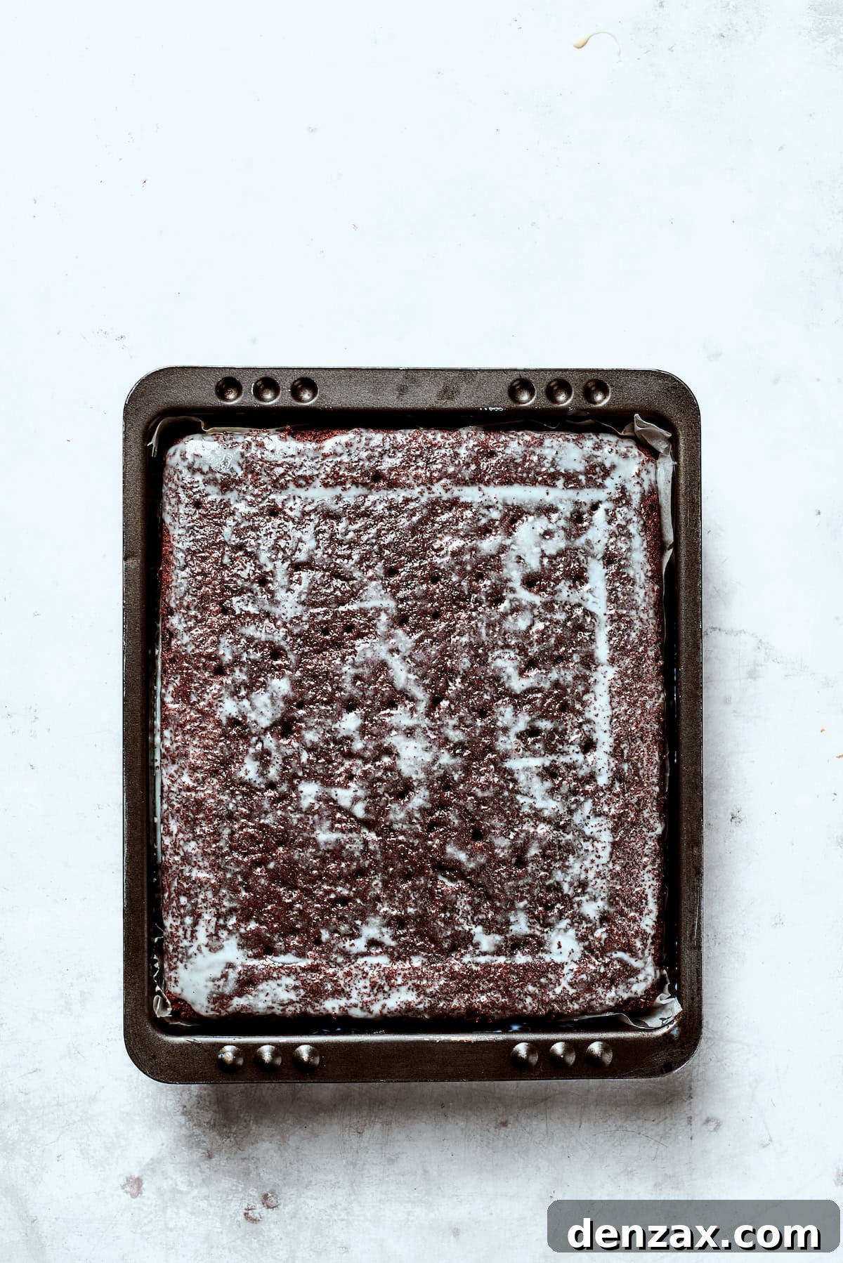 Condensed milk soaks into chocolate cake.