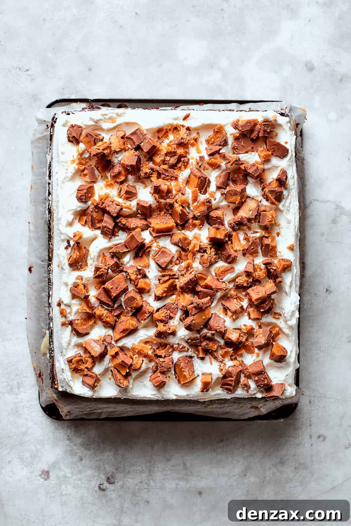 Chopped candy bars on top of a better than sex cake.