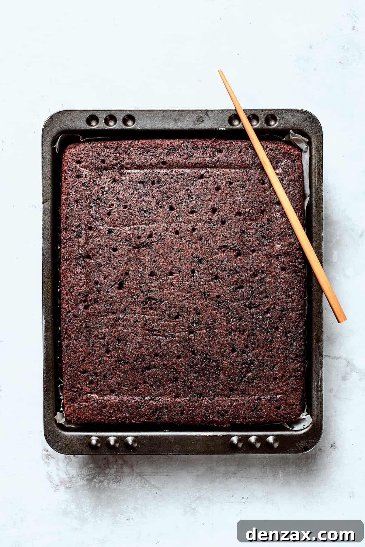 Chocolate cake cools in a tin.