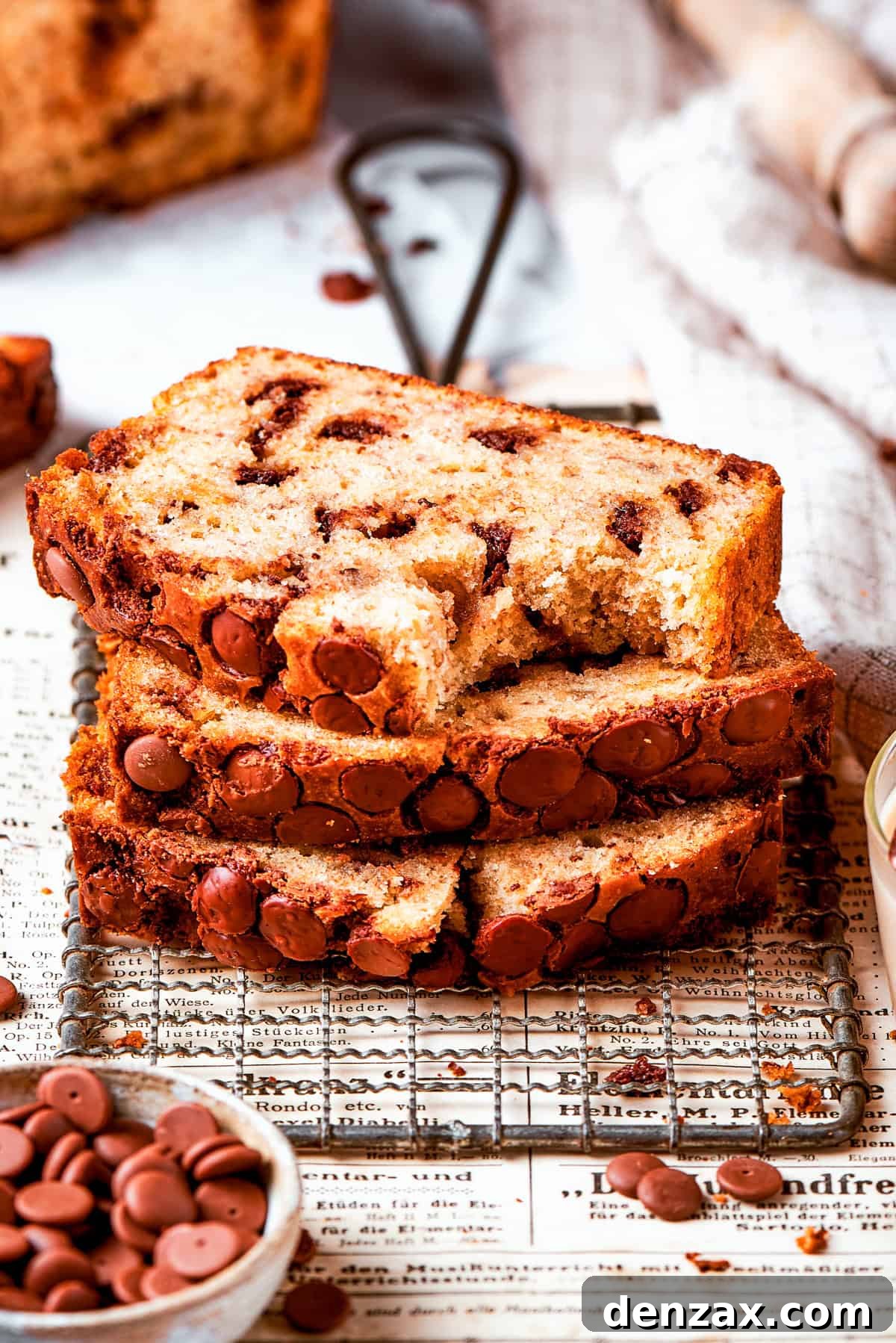 Three slices of banana chocolate chip bread stacked on top of each other.