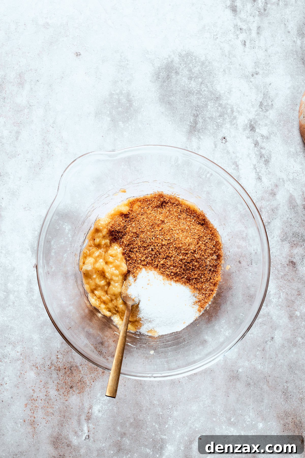 Sugar is added to mashed banana.