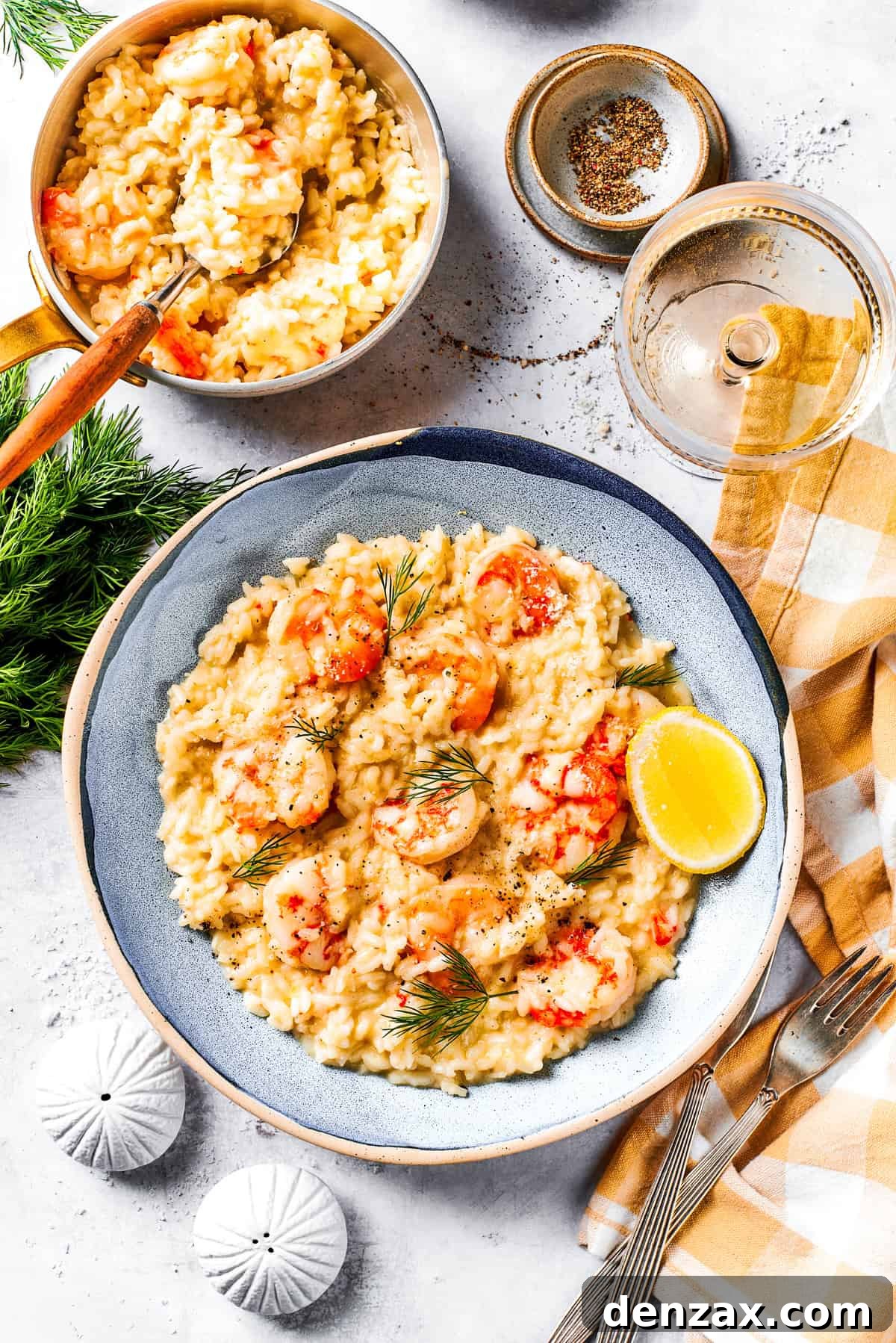 A serving of risotto with shrimp on a dinner plate.