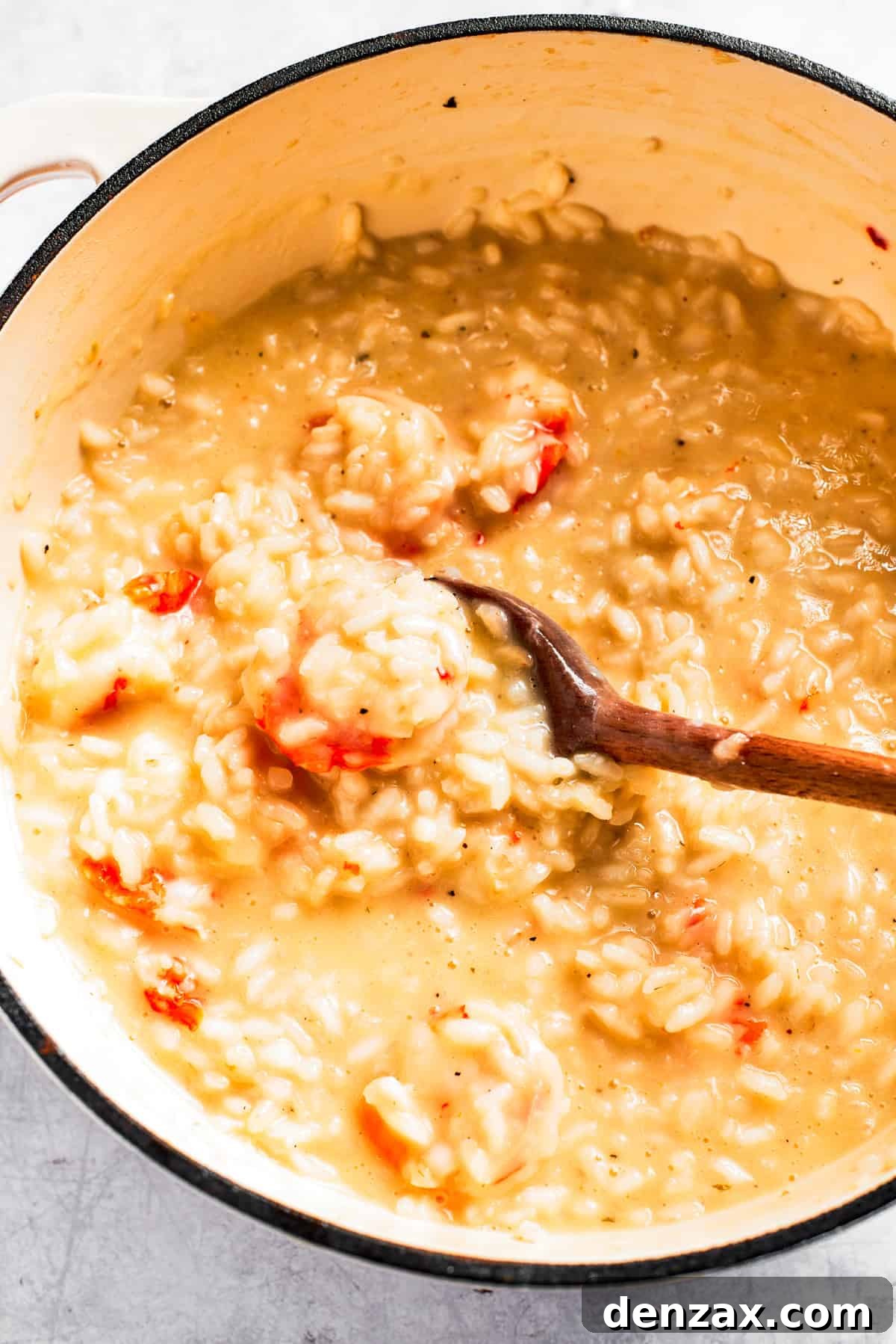 Stirring through rice in a pot.