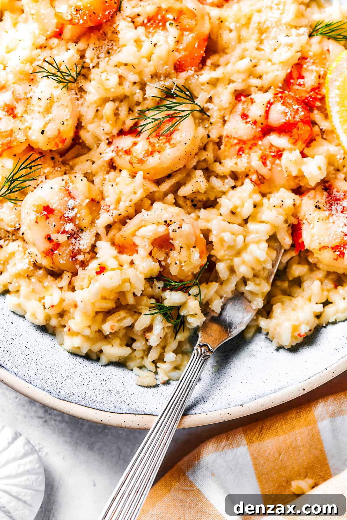 Rice and shrimp served on a dinner plate.