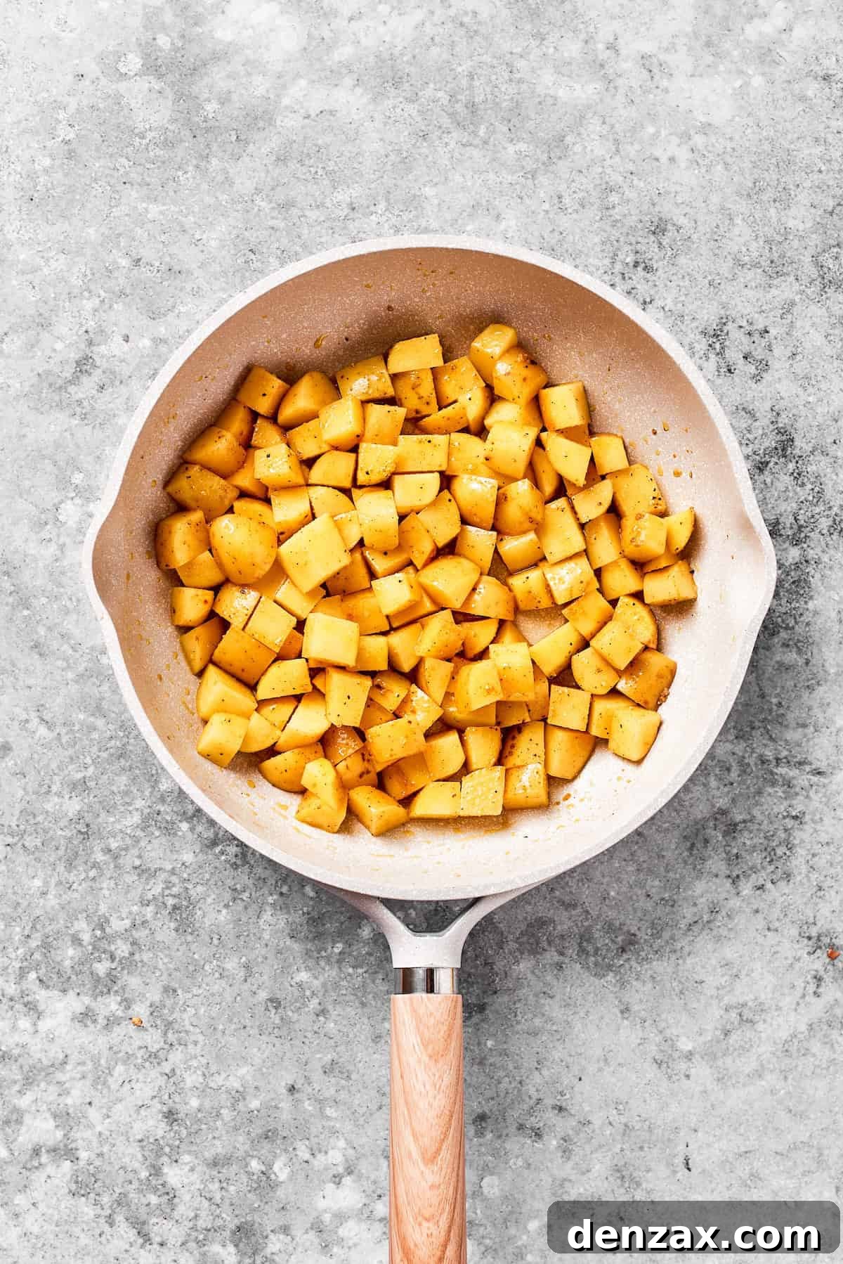 Cubes of potatoes browning in a skiillet.