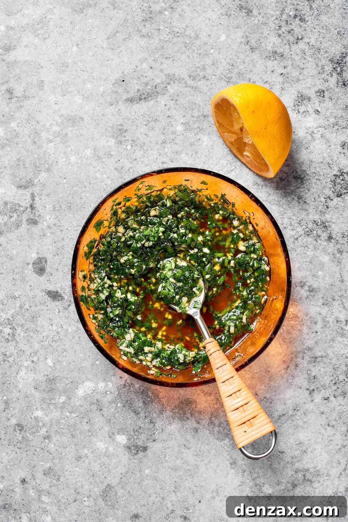 Herb sauce is stirred in a bowl.