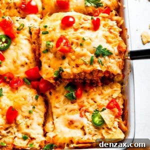 A serving utensil lifts out a scoop of Dorito casserole.