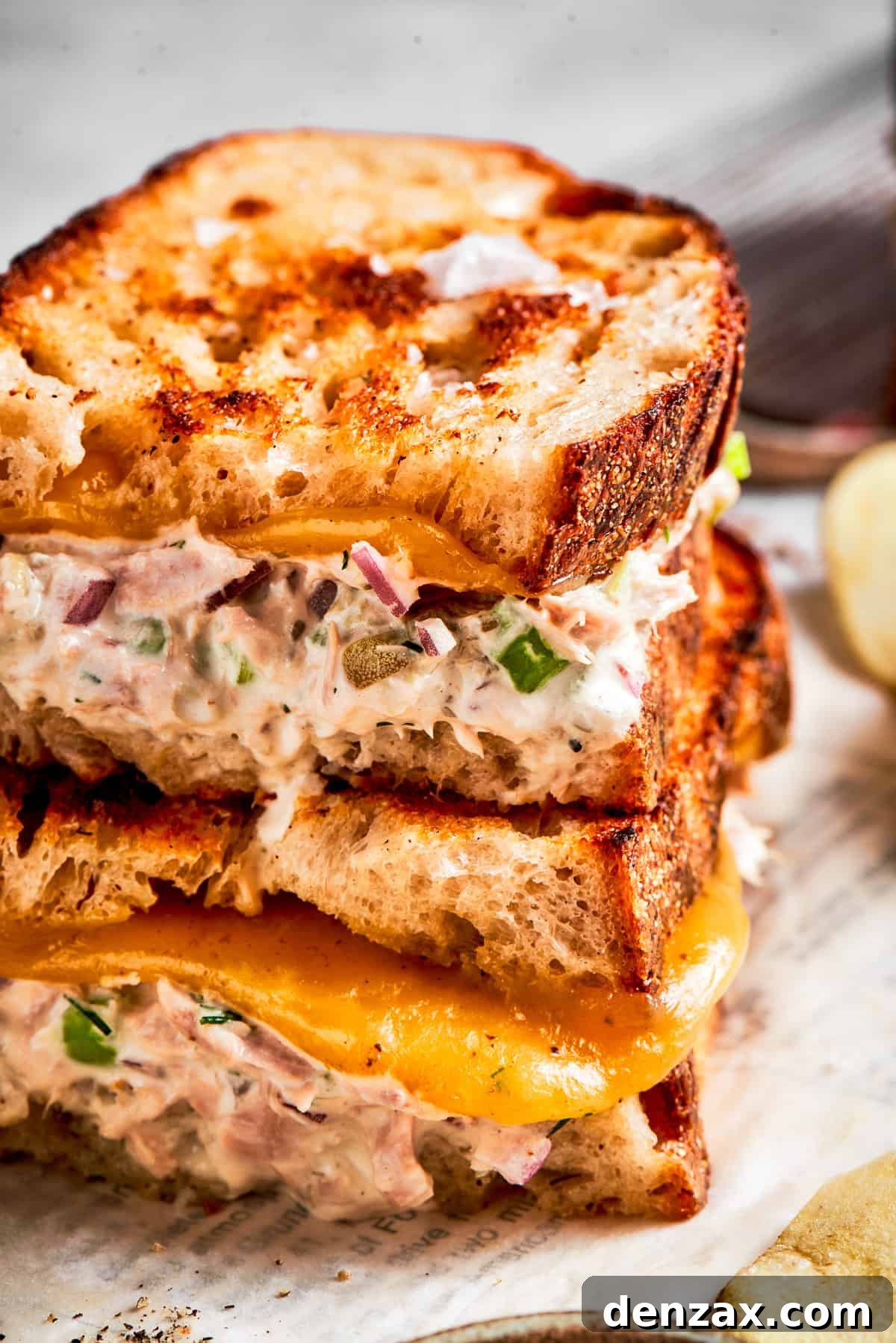 Close up shot of two tuna melt sandwiches stacked up.