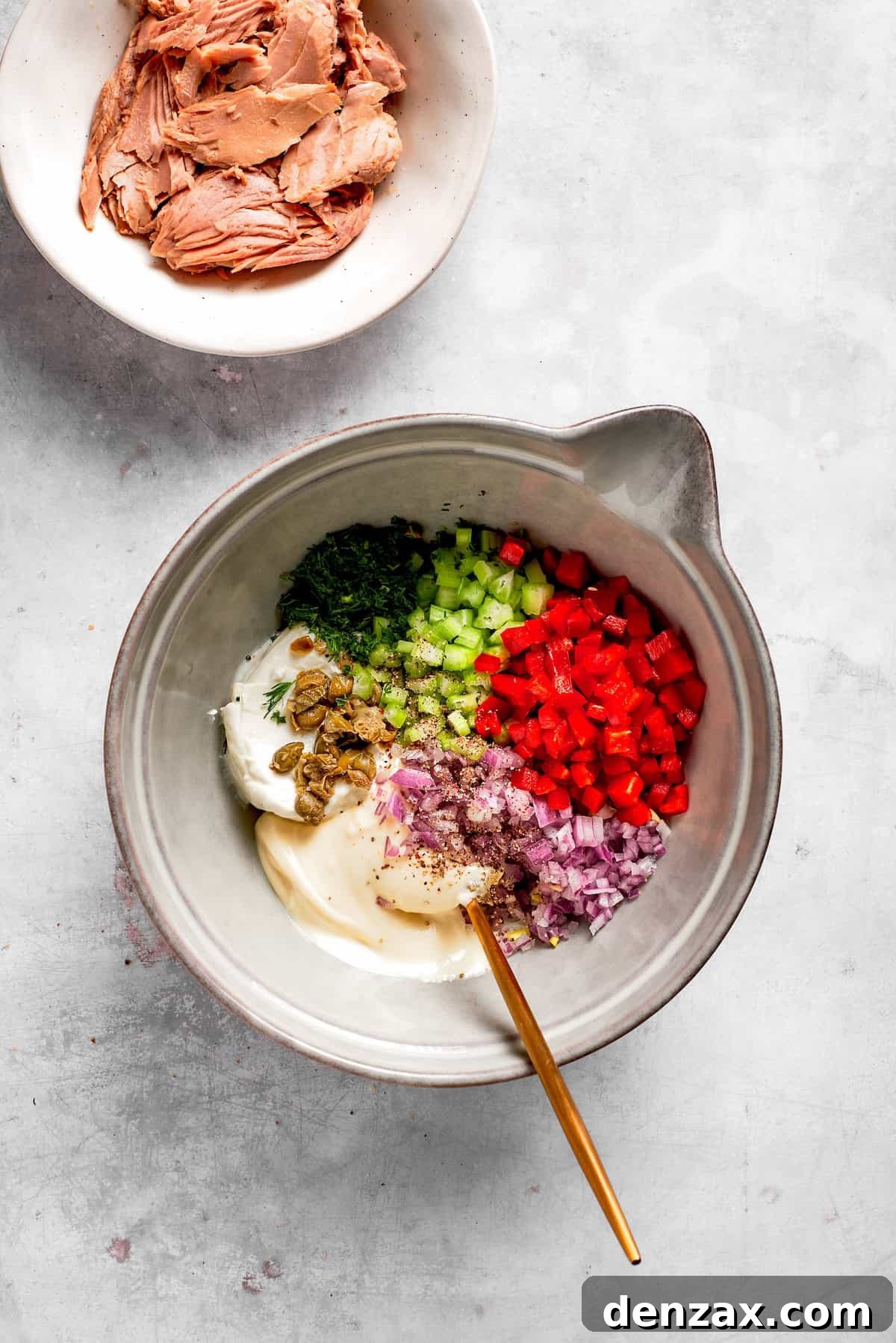 Vegetables and other ingredients in a bowl for tuna melt filling.