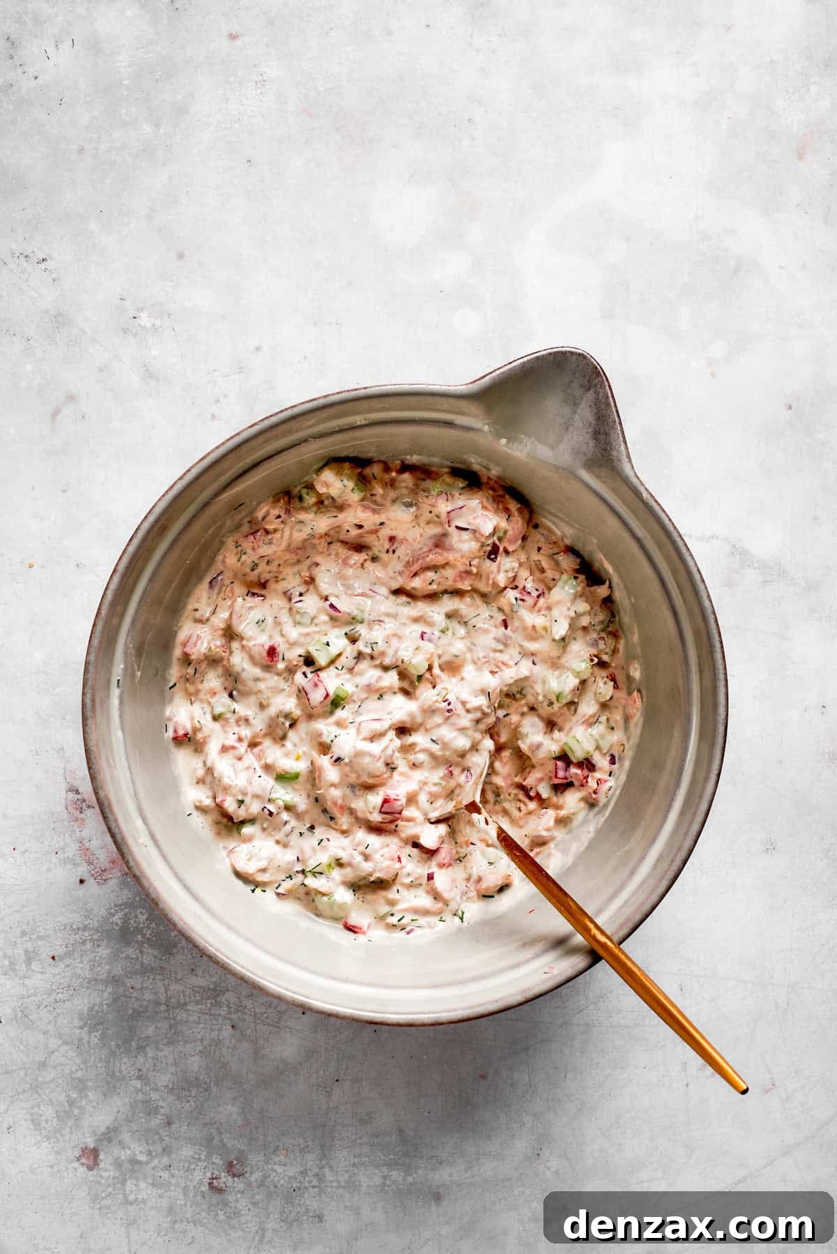 Ingredients for tuna melt filling are mixed together in a bowl.