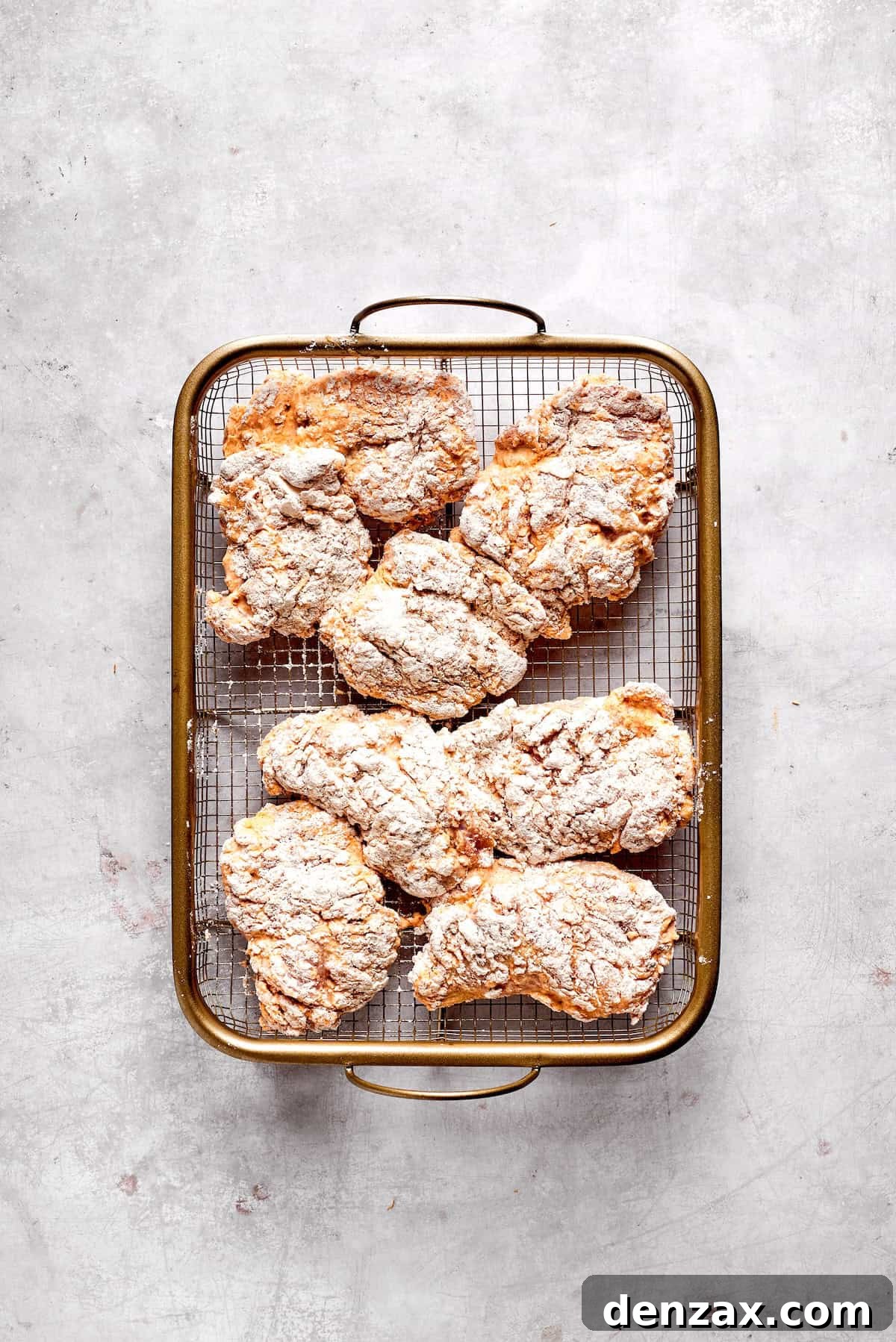 Coated pieces of chicken are ready to fry.