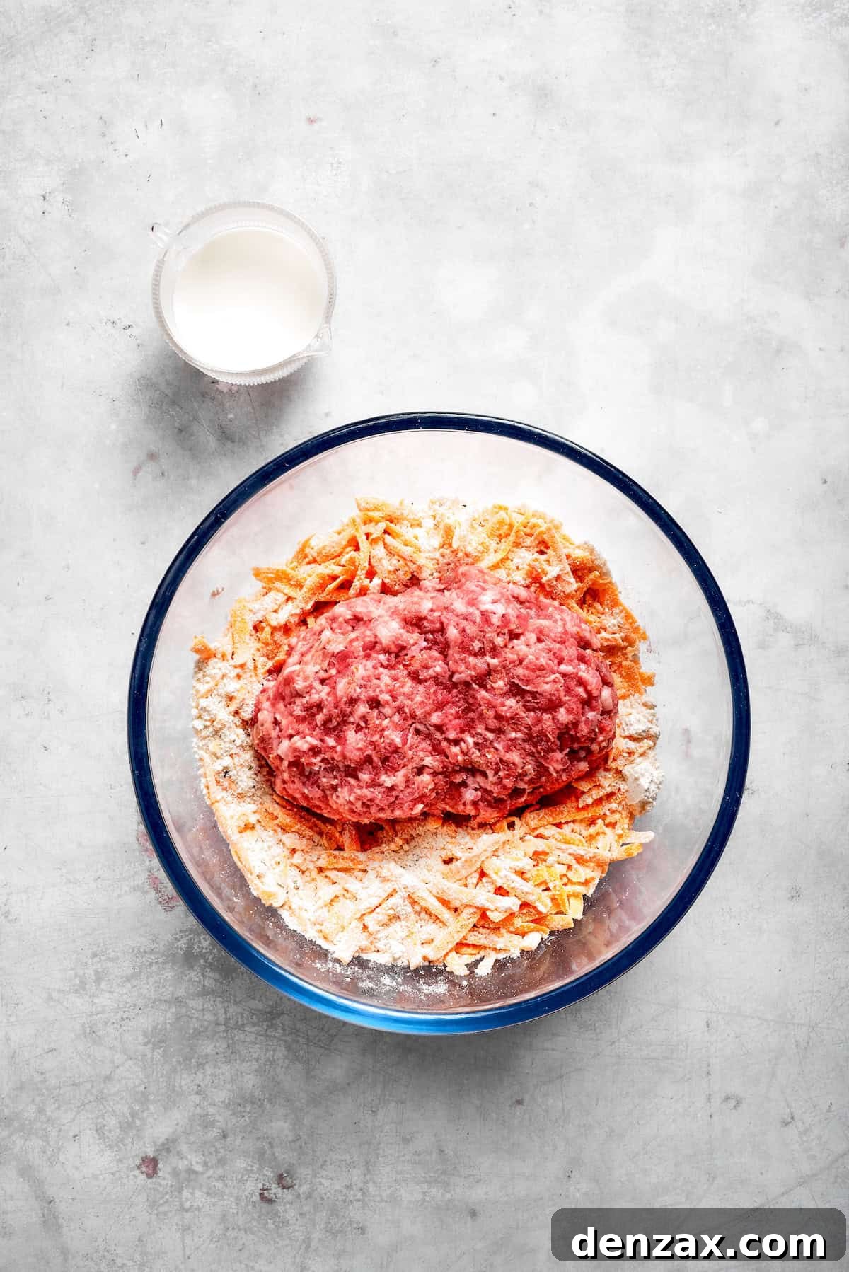 This sausage balls recipe relies on Bisquick, pork sausage, and Italian seasoning for an easy appetizer. Don't forget the dipping sauce! The ingredients for sausage balls placed in a glass bowl.