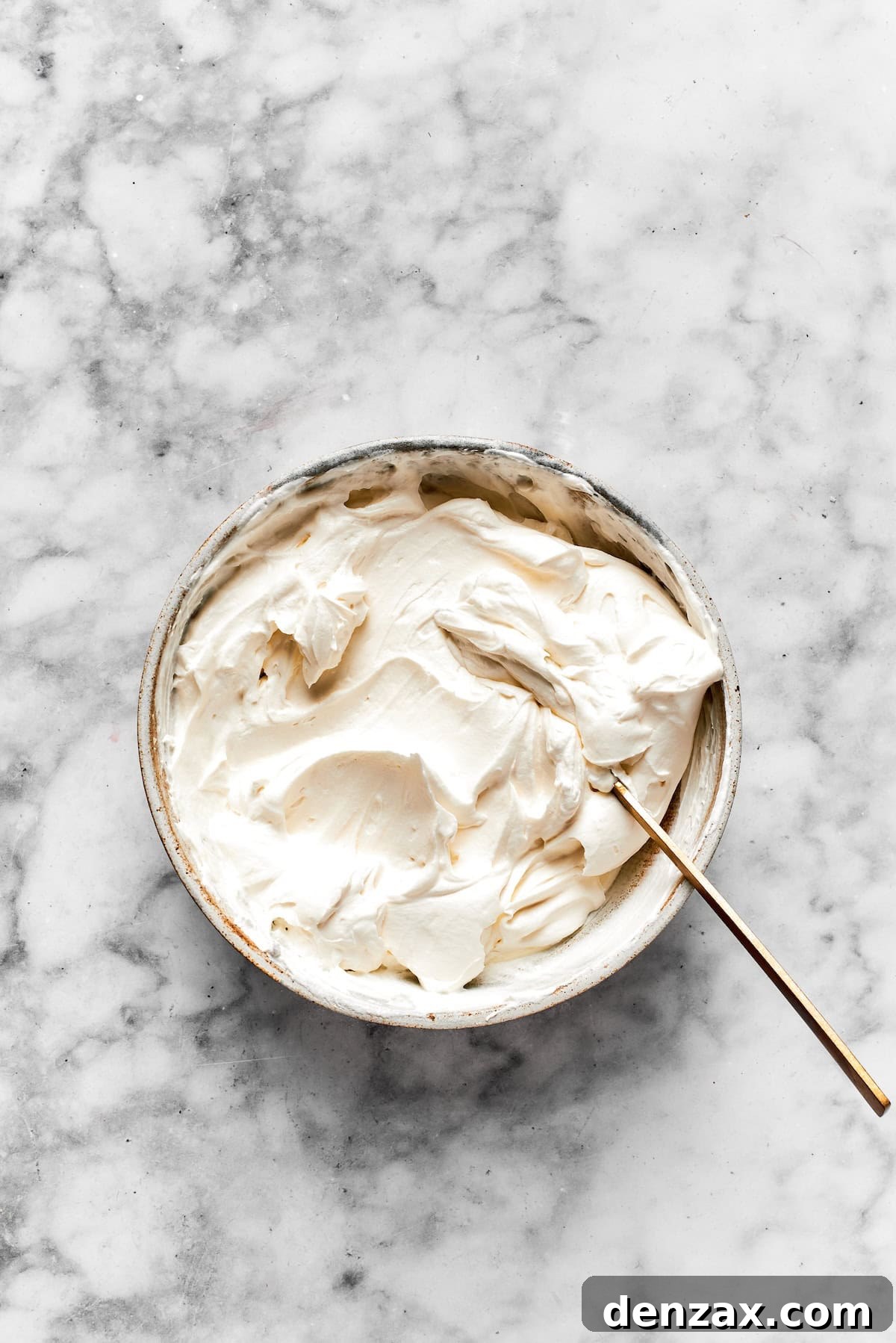 Cinnamon roll cheesecake frosting in a bowl.