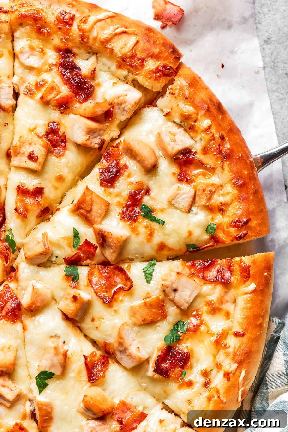 Cut slices of chicken bacon ranch pizza.