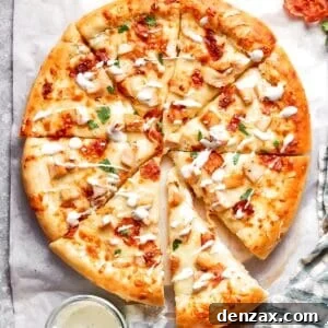 A chicken bacon ranch pizza served with sauce.