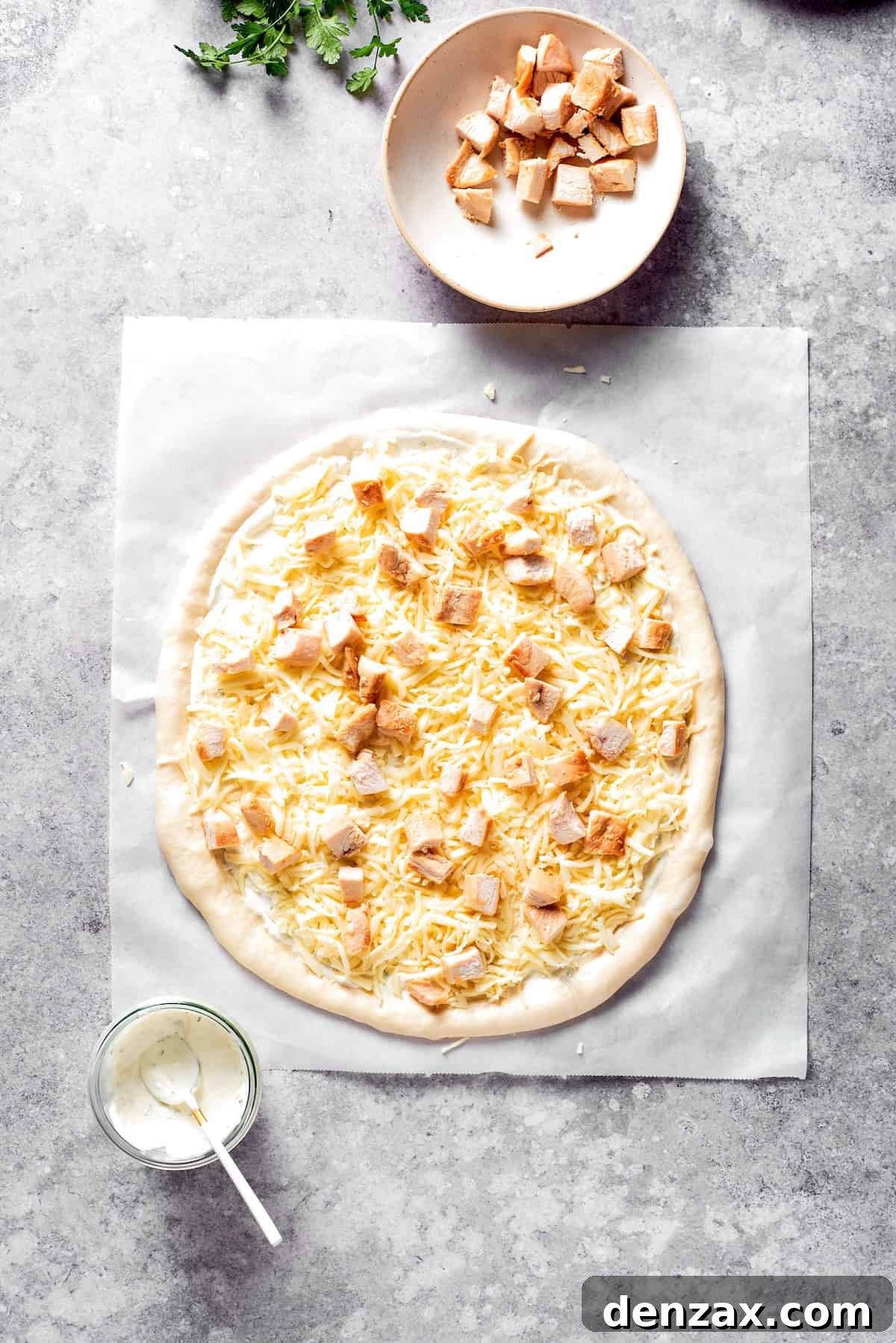 Chicken and shredded cheese added to pizza dough.
