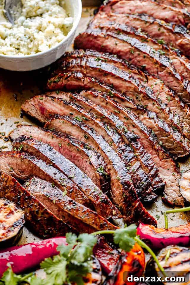 side close up shot of sliced grilled flank steak with a white bowl next to it