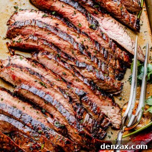top shot of grilled steak slices with a serving fork next to it