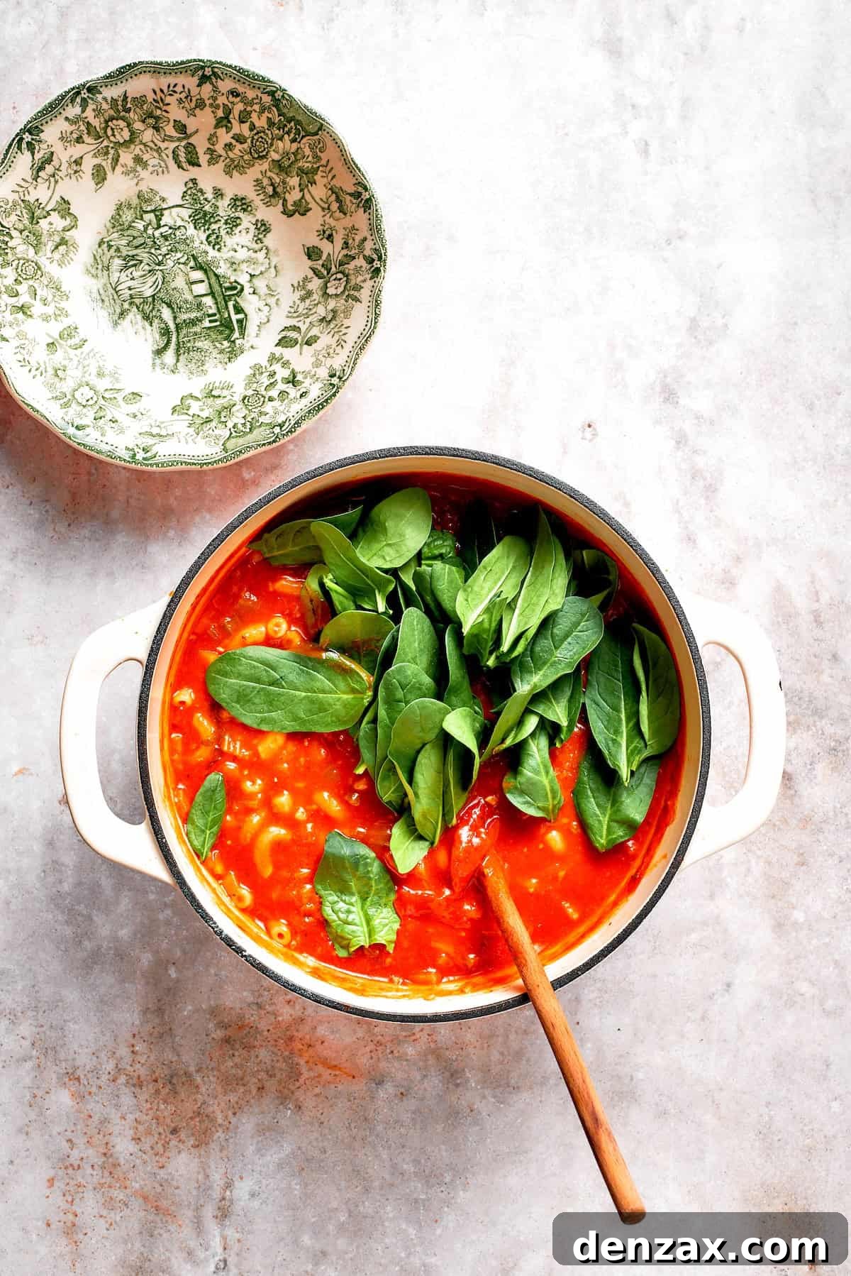 Spinach is stirred into tomato florentine soup.